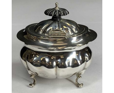 AN OVAL SILVER TEA/SUGAR CADDY - with single hinged lid and on four scrolled supports, fine clear marks, Birmingham 1906, 6.4