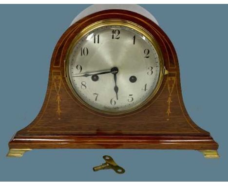ANTIQUE MAHOGANY PENDULUM DRIVEN MANTEL CLOCK - with garland inlay and on brass bracket feet, silvered dial with 8 day moveme