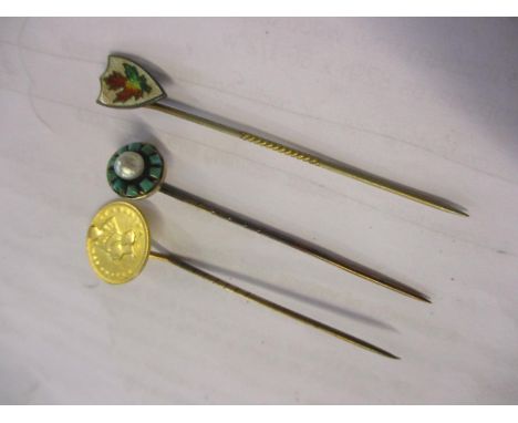 Three stick pins to include a 19th century stick pin with a 1873 one dollar coin 