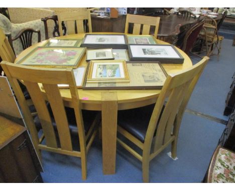 A light oak circular table and five dining chairs with  leather seats 