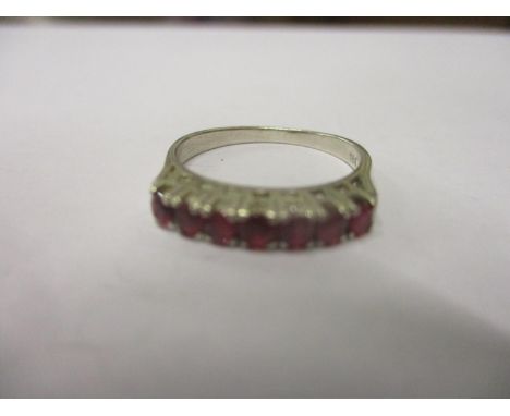 An 18ct white gold seven stone ruby ring 