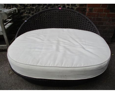 A modern garden low cane two seater sofa with removable cushion, 29 1/2" h x 57"w 