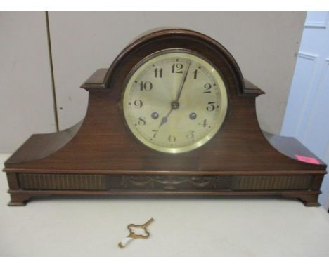An Edwardian mahogany Napoleon hat mantle clock with silvered Arabic dial and twin winding holes and key 