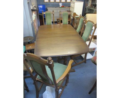 An Ercol extending dining table 28 3/4"h x 63"w, together with six matching chairs 