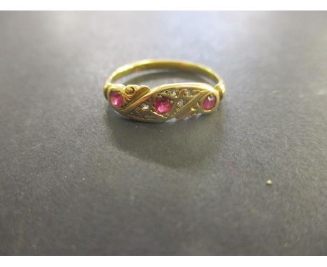 A gold coloured metal diamond and ruby ring, stamped 18ct, 2.25g 