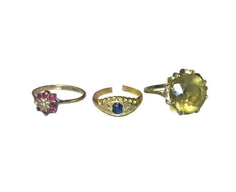 A group of three gem set gold rings. Comprising a sapphire and diamond 18ct gold dress ring with cut shank;&nbsp; a 9ct gold 