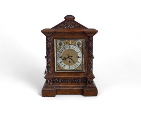 A good quality carved oak Victorian bracket clock, with a triple fusee movement, striking and chiming on 5 gongs with repeat,