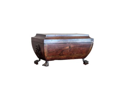 A Regency brass inlaid rosewood two section tea caddy on hairy claw feet. 35cm by 18cm by 19cm. Some losses/wear consistent w