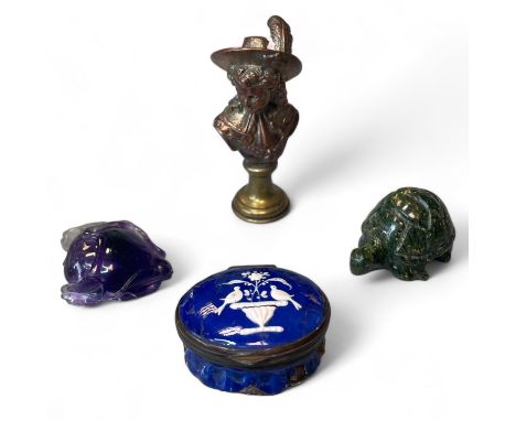 A collection of decorative items comprising a brass seal, engraved with an armorial crest featuring winged spurs, with the ha