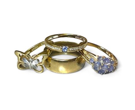 Four 9ct gold rings. Featuring a tanzanite and diamond set ring, size R; a tanzanite cluster ring, size Q; a 9ct gold butterf