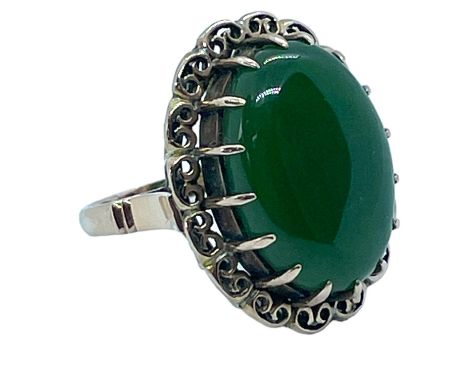 A Nephrite jade cocktail ring. Stamped "14k" and testing accordingly. Size M1/2. Approximate gross weight 8.4 grams
