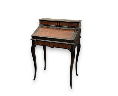 A 19th Century burr wood ebonised Bonheur-du-jour writing desk with two small drawers above a sloping fold down front encasin
