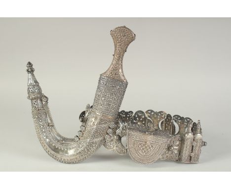 A FINE OMANI / EMIRATI SILVER DAGGER AND BELT, heavy solid silver.