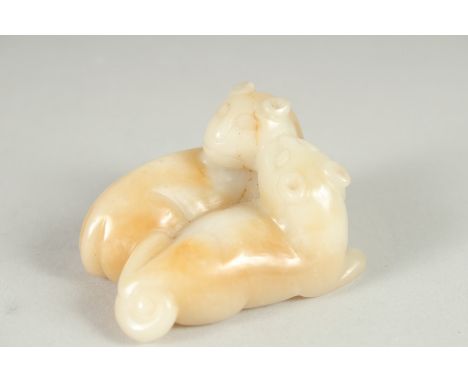 A FINE CHINESE CARVED JADE FIGURE OF TWO LIONS, 6.5cm at widest point.