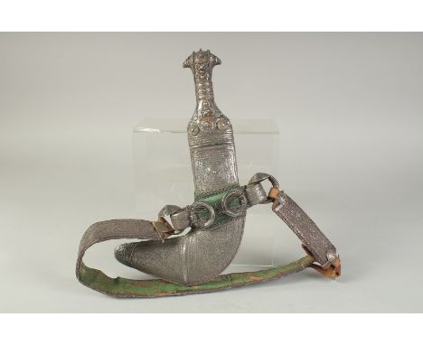 A FINE OMANI SILVER DAGGER AND BELT.