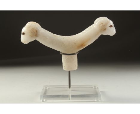 A FINE 19TH-EARLY 20TH CENTURY MUGHAL INDIAN CARVED WHITE JADE CRUTCH HANDLE, formed with two ram's head terminals, eyes poss