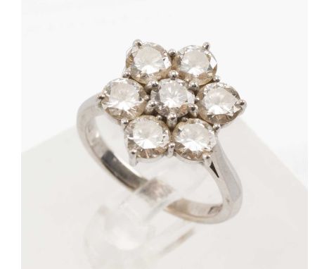 18CT WHITE GOLD DIAMOND CLUSTER RING, set with seven brilliant cut diamonds in a flower shape, shank stamped HC Ltd., ring si