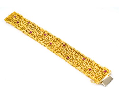 18CT GOLD & RUBY BRACELET, maker SS, import marks for London 1966, pierced and textured goldwork set with eleven cut rubies, 