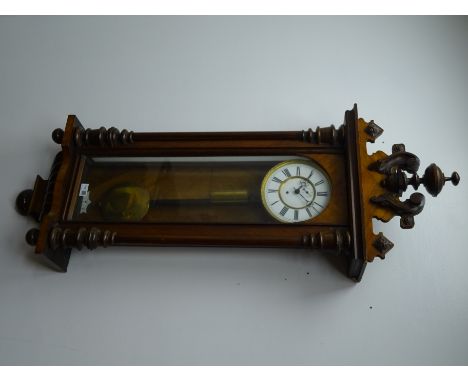 Late 19th century Vienna style walnut wall clock with carved pediment over a glazed door flanked by turned half columns enclo