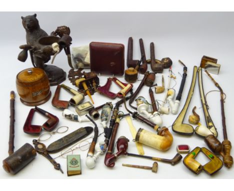 Black forest style pipe stand carved as a standing bear, carved and plain Meerschaum, matchbox covers including military, var