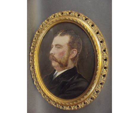 An overpainted photographic portrait of an Edwardian gentleman, in a good pierced oval frame, 11" x 9" 