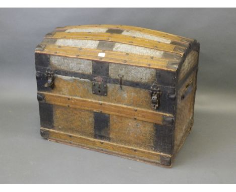 A C19th dome topped trunk with steel mounts and fitted interior, 34" x 22" x 29" 