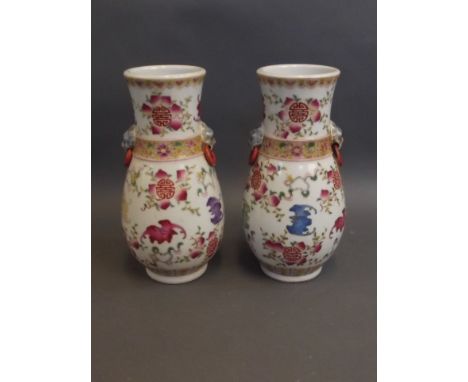 A pair of Chinese twin handled vases with dragon head handles and painted enamel bat and peach decoration, 5 character mark t