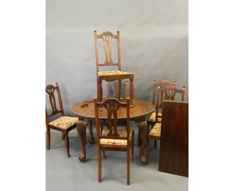 A set of six Maple & Co. walnut dining chairs with shaped pierced splat backs, and a small oval wind-out dining table with ex