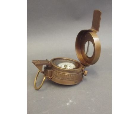 A brass cased field compass, inscribed 'T.G. & Co.', 2½" diameter 