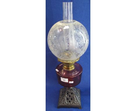 Early 20th Century brass double burner oil lamp, having cranberry glass reservoir and pierced metal base, etched glass shade 