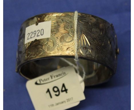 Silver scroll engraved bangle.