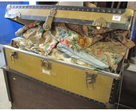 Vintage metal and brass bound trunk containing various floral curtains etc.