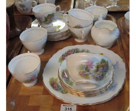 Tray of Royal Vale bone china teaware on a white and gilt ground with cottage scenes, comprising: teacups and saucers; milk j