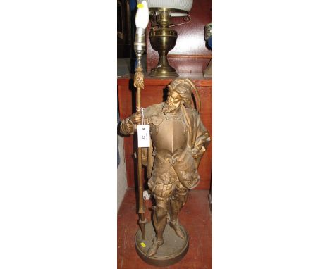 Large Spelter figural lamp in the form of a knight in armour. CONDITION REPORT: Has been painted gold. Sword missing. Wrist h