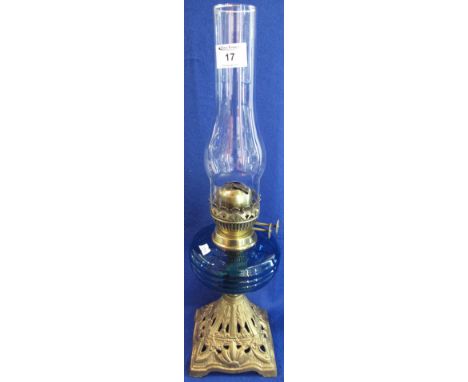 Early 20th Century brass double burner oil lamp with coloured, moulded glass reservoir on cast gilt metal base, and having cl