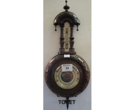 Small early 20th Century aneroid wheel barometer with carved walnut case, the face marked: Bird of Hull.