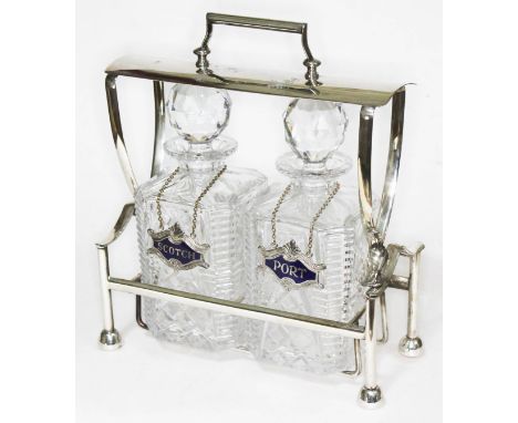 A Falstaff silver plated two bottle tantalus with scotch and port labels.  