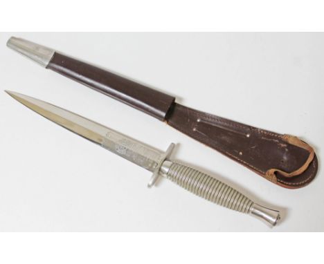 A Wilkinson Sword Fairbairn-Sykes commando knife and leather scabbard.  