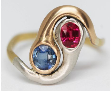 An entwined snake head ring set with a sapphire and a ruby, white metal setting and yellow metal band, marked 18ct, gross wt.