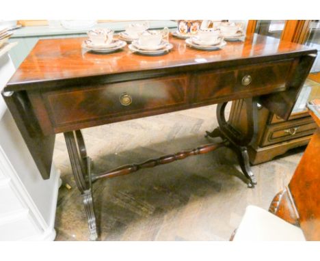 A reproduction mahogany sofa table on lyre shaped ends 