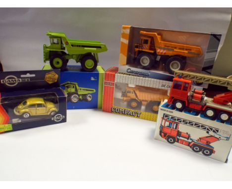 Mix of trucks to include three dumper trucks, one fire engine and one VW Beetle. All boxed in used condition 