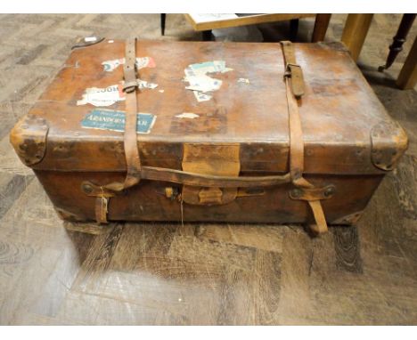 A Vintage leather Steamer trunk with some old luggage labels 