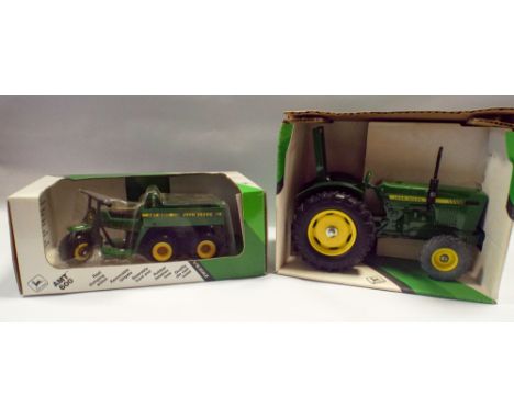 Two ERTL John Deere vehicles, to include a John Deere tractor No581 and All Materials Transport vehicle No600. Boxed and in g