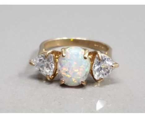 9CT YELLOW GOLD OPAL AND CZ 3 STONE RING FEATURING A OVAL SHAPED OPAL SET IN THE CENTRE SET WITH A CZ STONE ON EACH SIDE 4G G