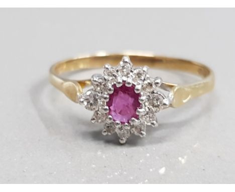 9CT YELLOW GOLD RUBY AND CLUSTER RING FEATURING A OVAL RED STONE IN THE CENTRE SURROUNDED BY 12 BRILLIANT ROUND CUT DIAMONDS 