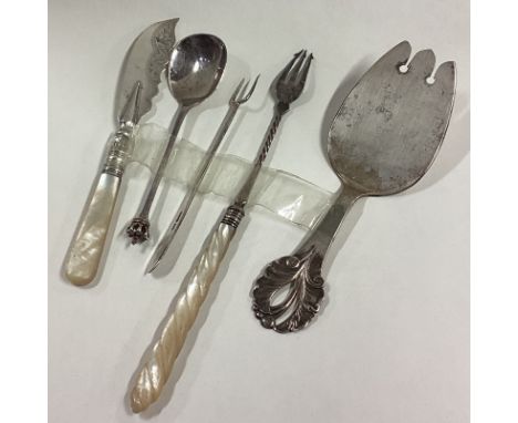 A stylish silver slice together with a pickle fork etc. Approx. 142 grams. Est. £60 - £80.