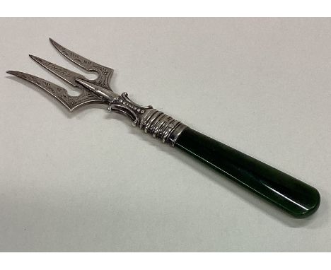 A silver three prong fork with agate handle. Approx. 21 grams. Est. £30 - £40.