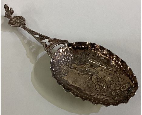 A silver caddy spoon with figural decoration bearing import marks. Approx. 34 grams. Est. £40 - £60.