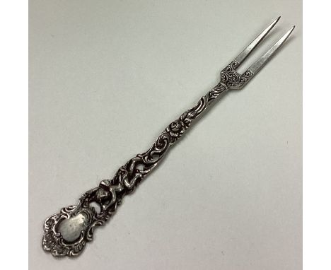 A Continental silver fork with pierced cherub decoration. Approx. 20 grams. Est. £20 - £30.