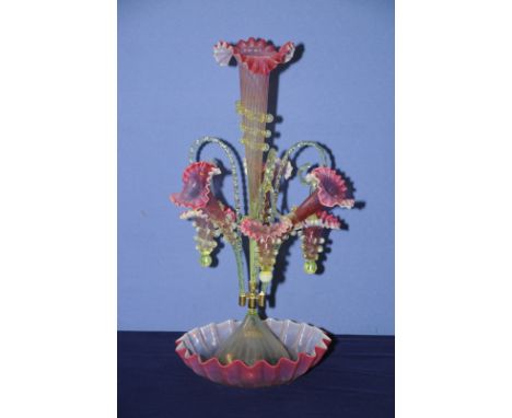 Victorian cranberry and vaseline glass six branch epergne with large central ribbed trumpet vase, three separate trumpet vase